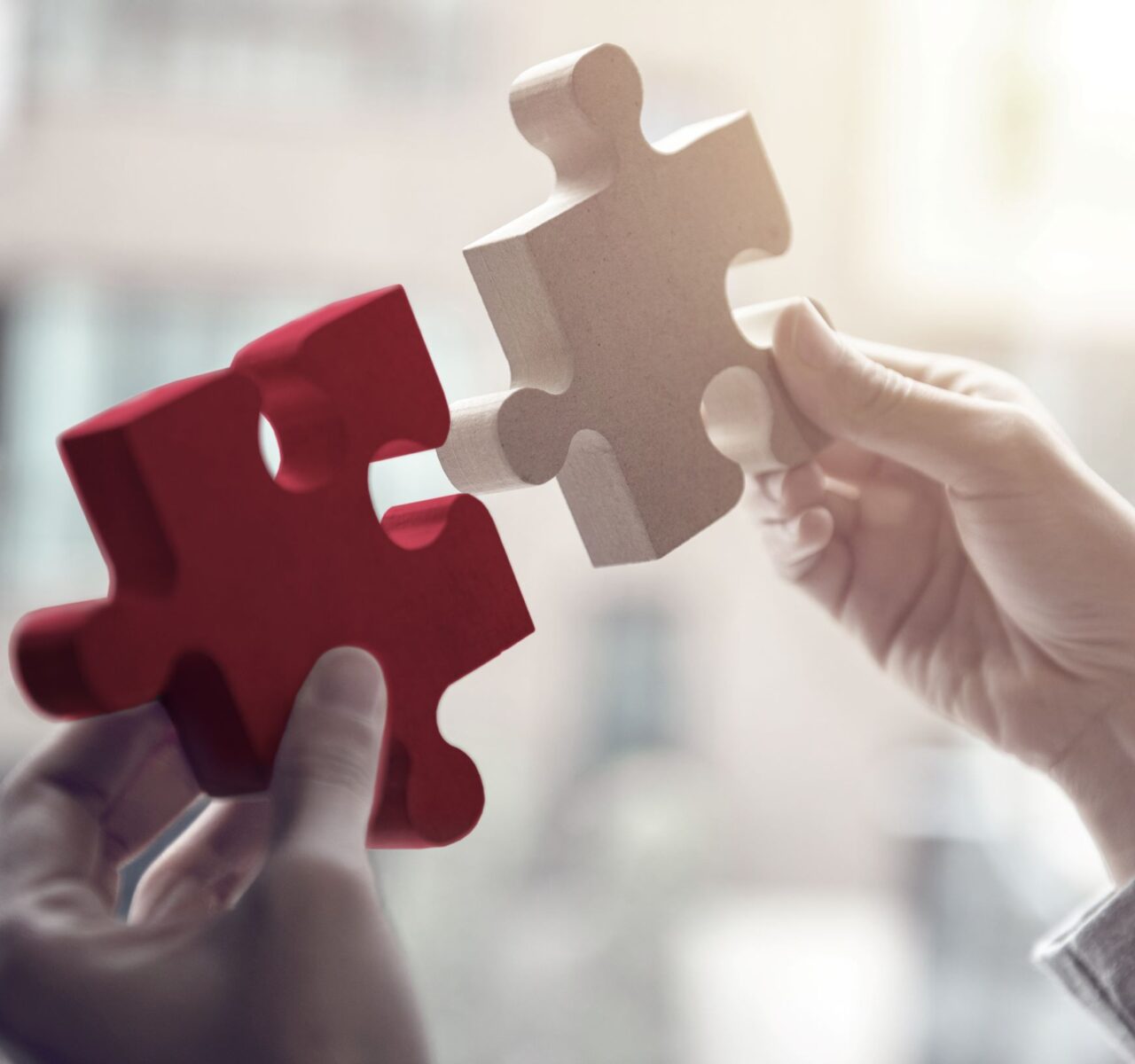 Two hands fitting puzzle pieces together, symbolising legal resolution and collaboration in inheritance dispute cases